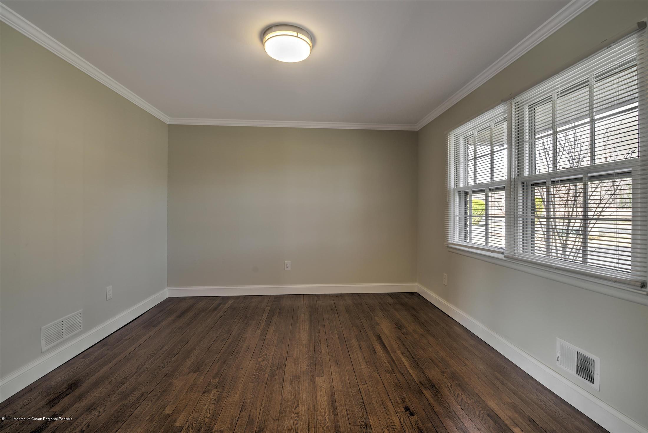 518 East Freehold Road Freehold, NJ 07728 - Photo 16 of 35 an empty room with wooden floor and windows
