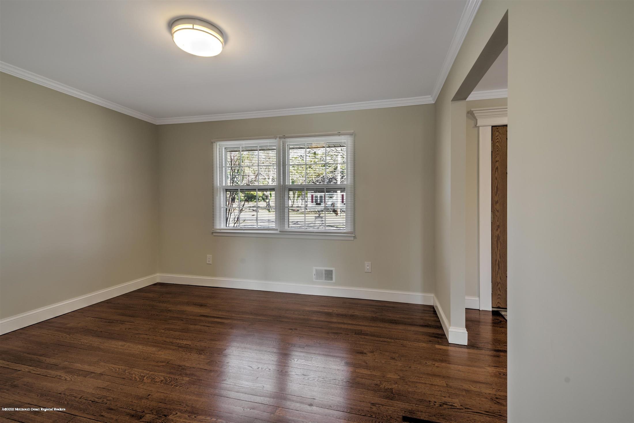 518 East Freehold Road Freehold, NJ 07728 - Photo 17 of 35 an empty room with wooden floor and windows