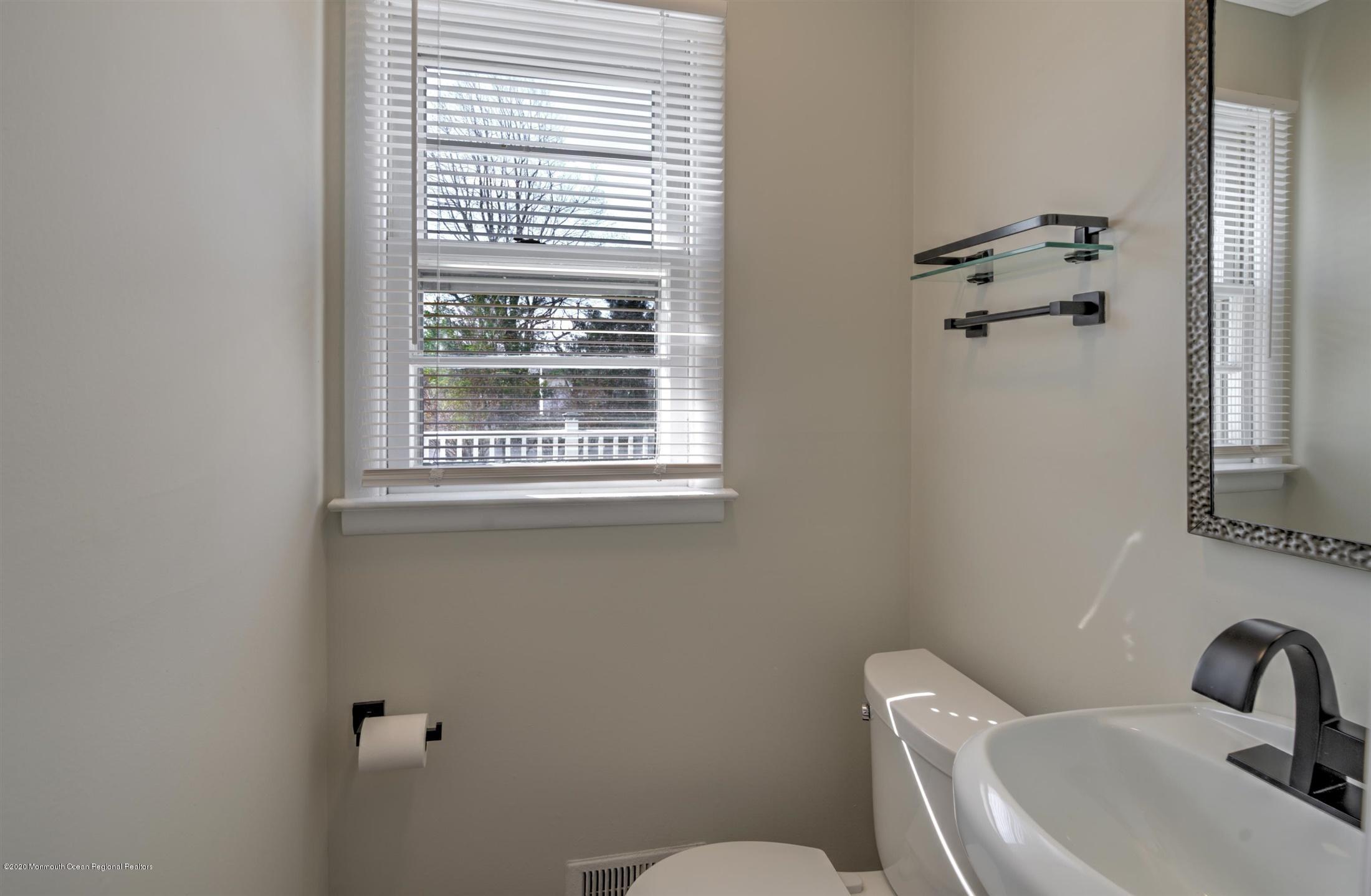 518 East Freehold Road Freehold, NJ 07728 - Photo 18 of 35 a bathroom with a toilet sink and mirror