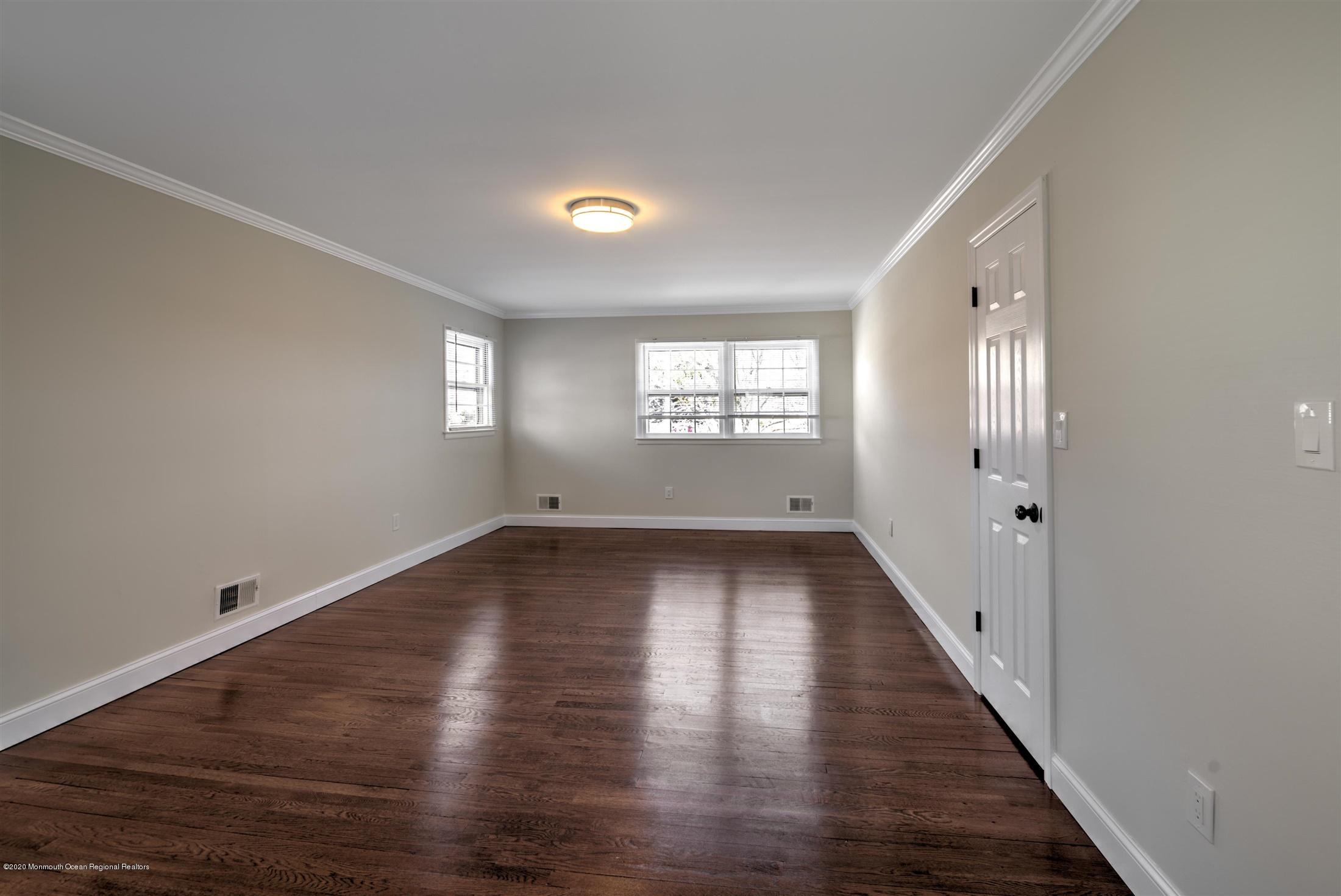518 East Freehold Road Freehold, NJ 07728 - Photo 19 of 35 an empty room with wooden floor and windows