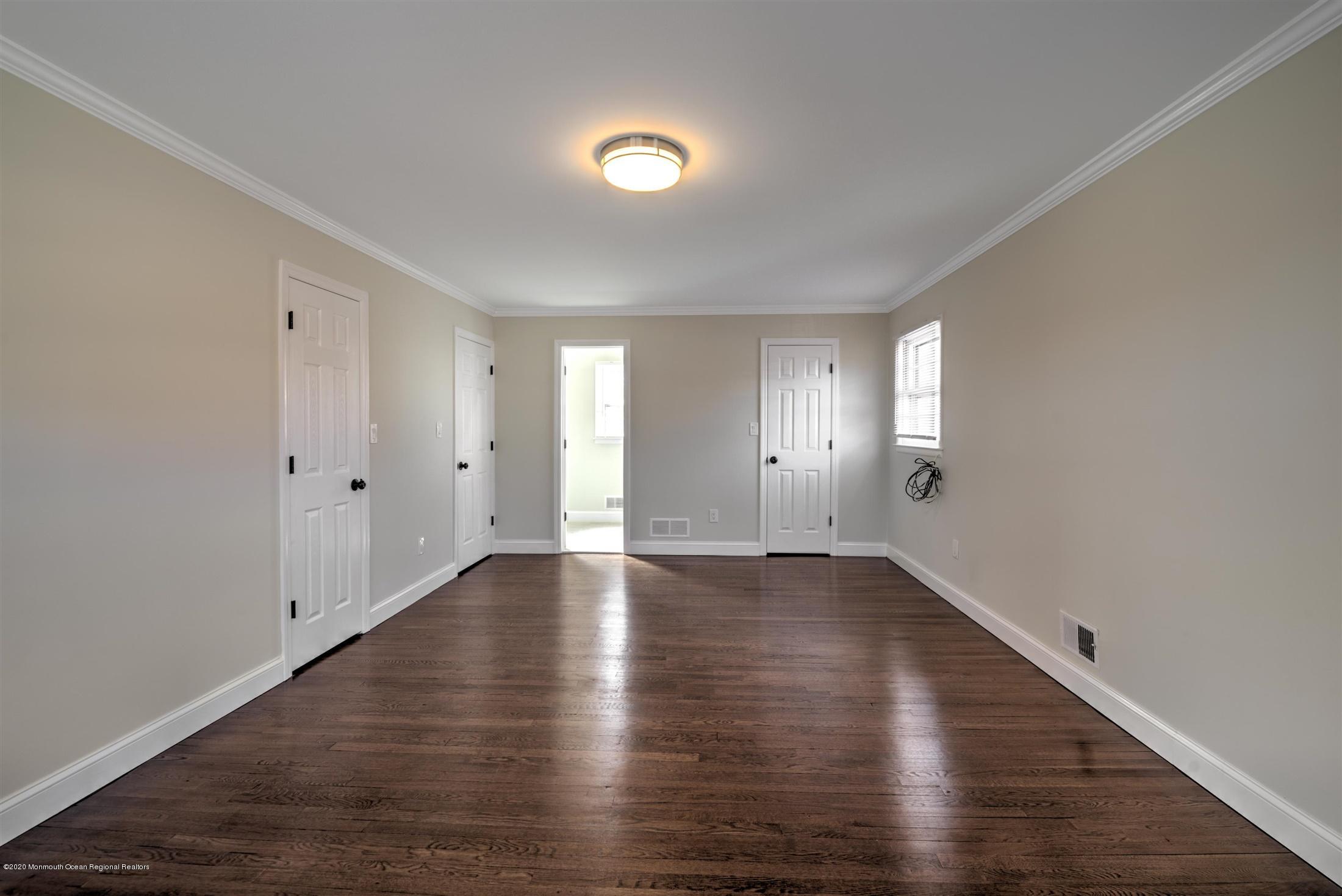 518 East Freehold Road Freehold, NJ 07728 - Photo 20 of 35 an empty room with wooden floor and windows