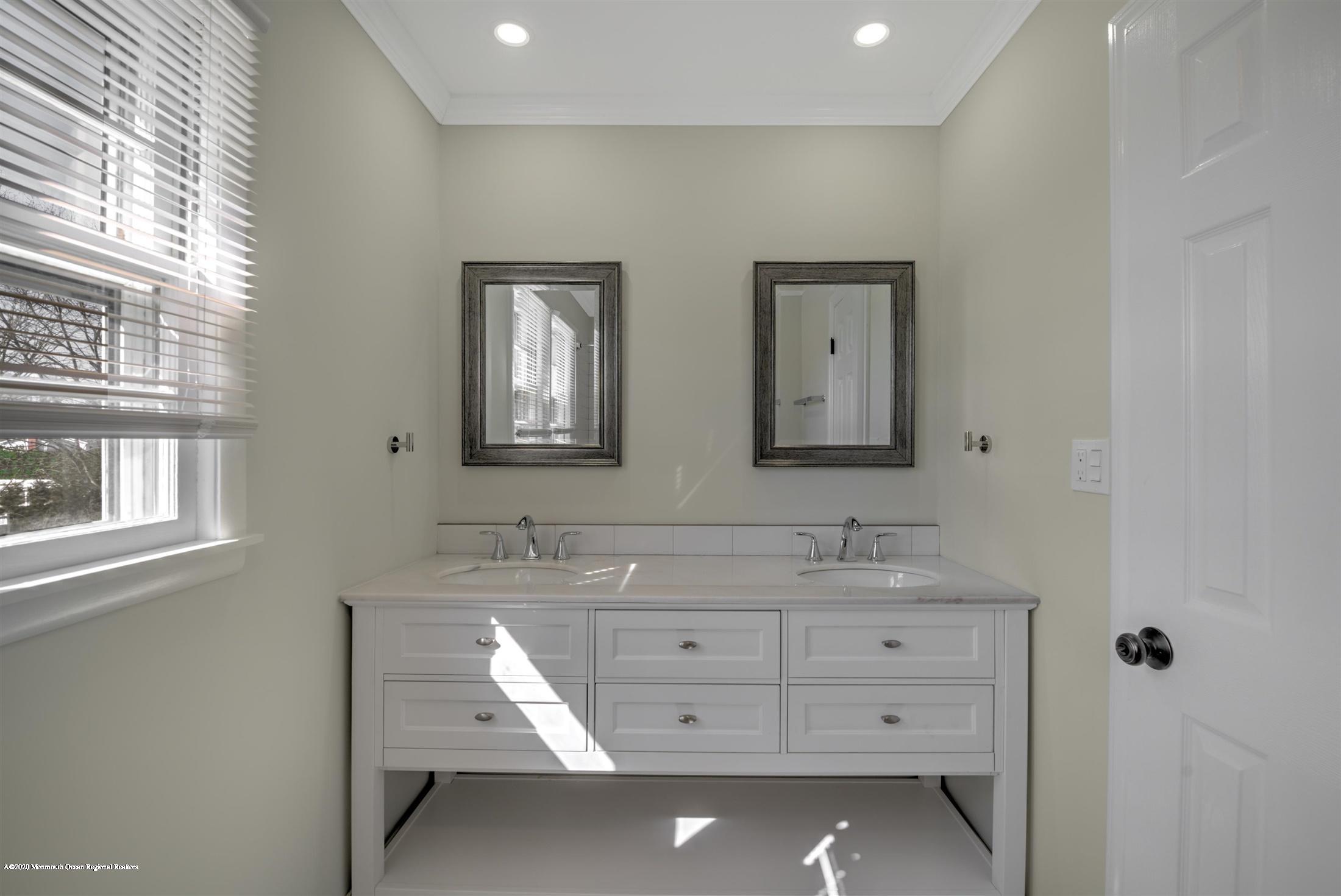 518 East Freehold Road Freehold, NJ 07728 - Photo 27 of 35 a bathroom with a double vanity sink and a mirror