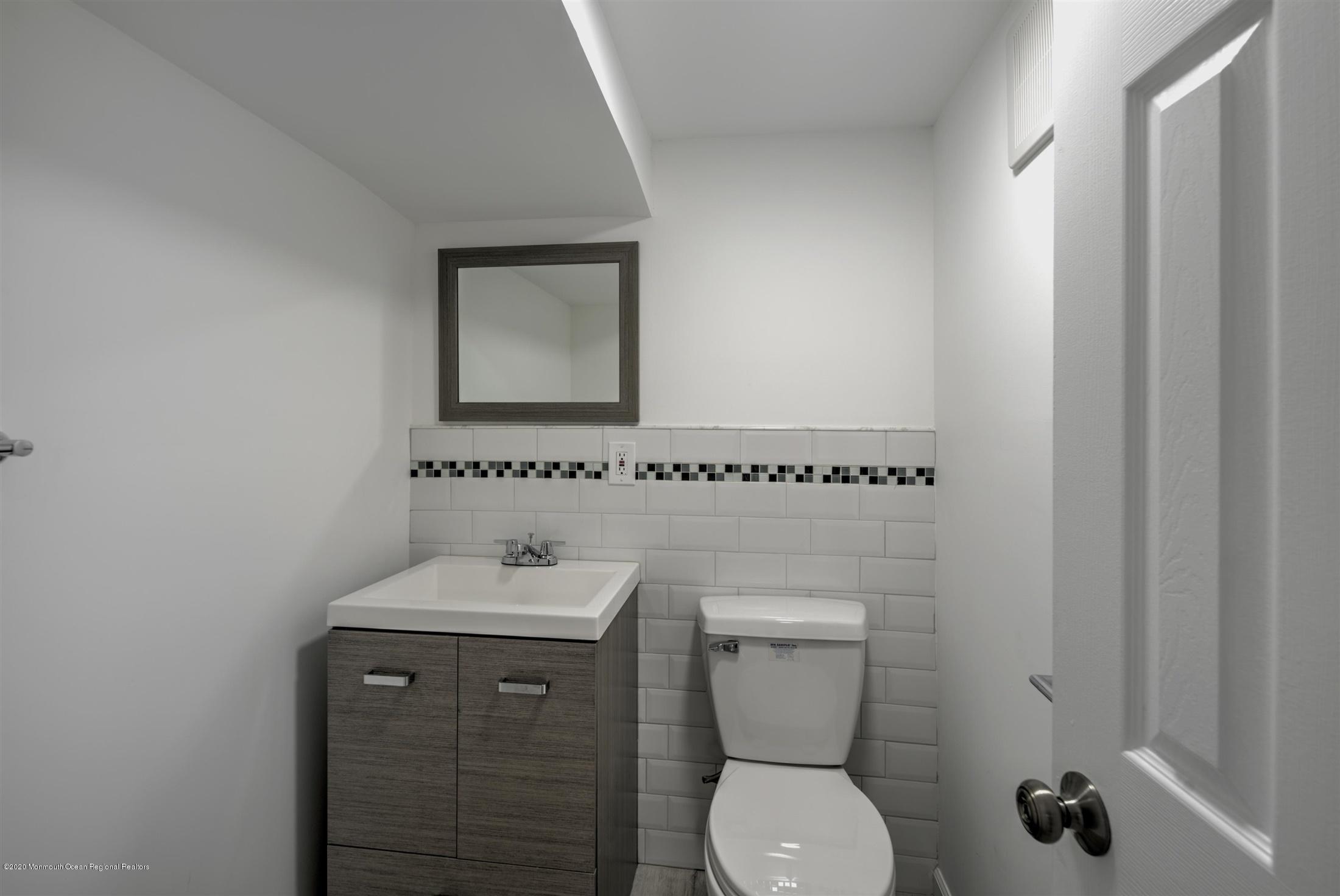 518 East Freehold Road Freehold, NJ 07728 - Photo 30 of 35 a bathroom with a toilet sink and mirror