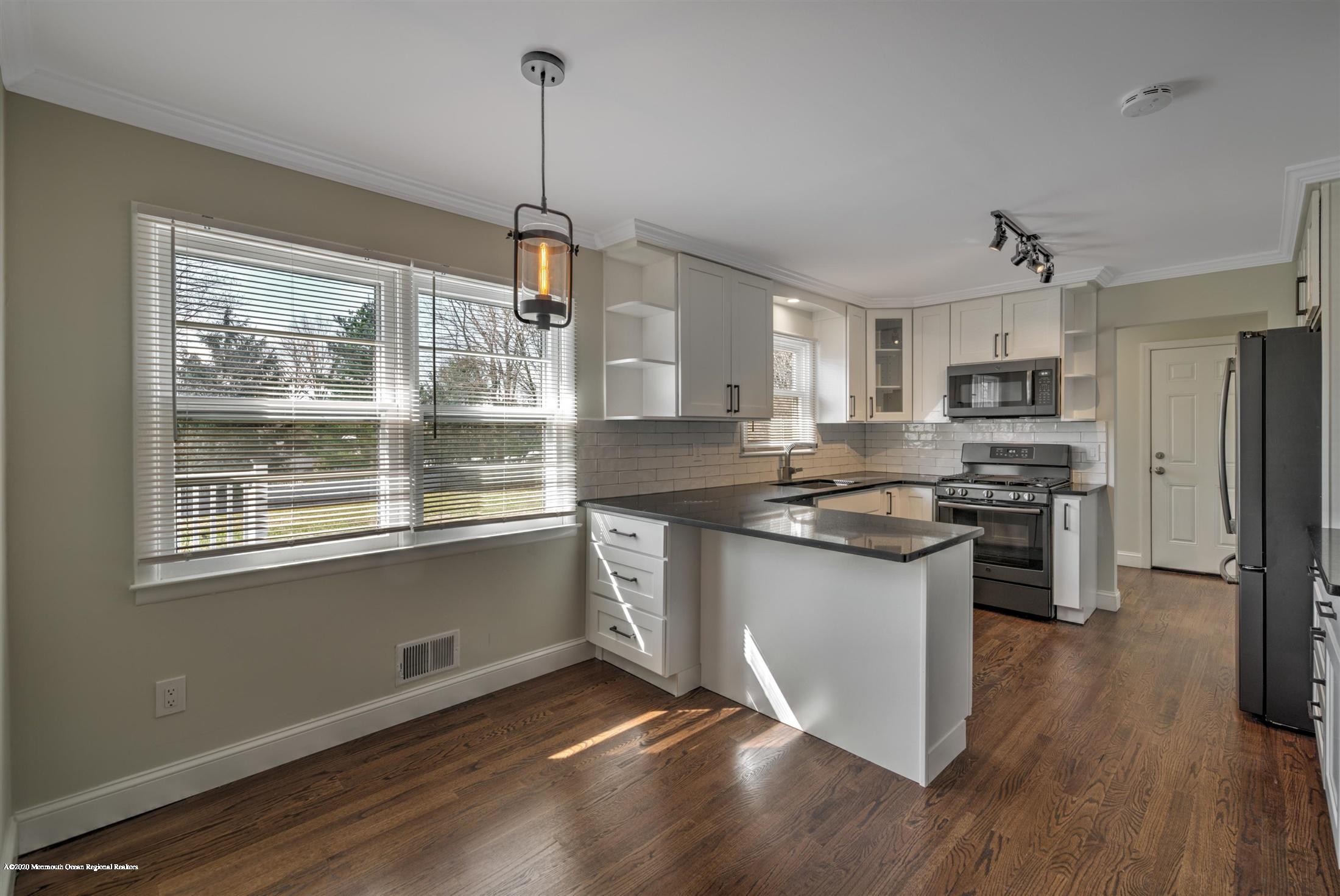 518 East Freehold Road Freehold, NJ 07728 - Photo 4 of 35 a kitchen with stainless steel appliances granite countertop a stove a sink and a refrigerator