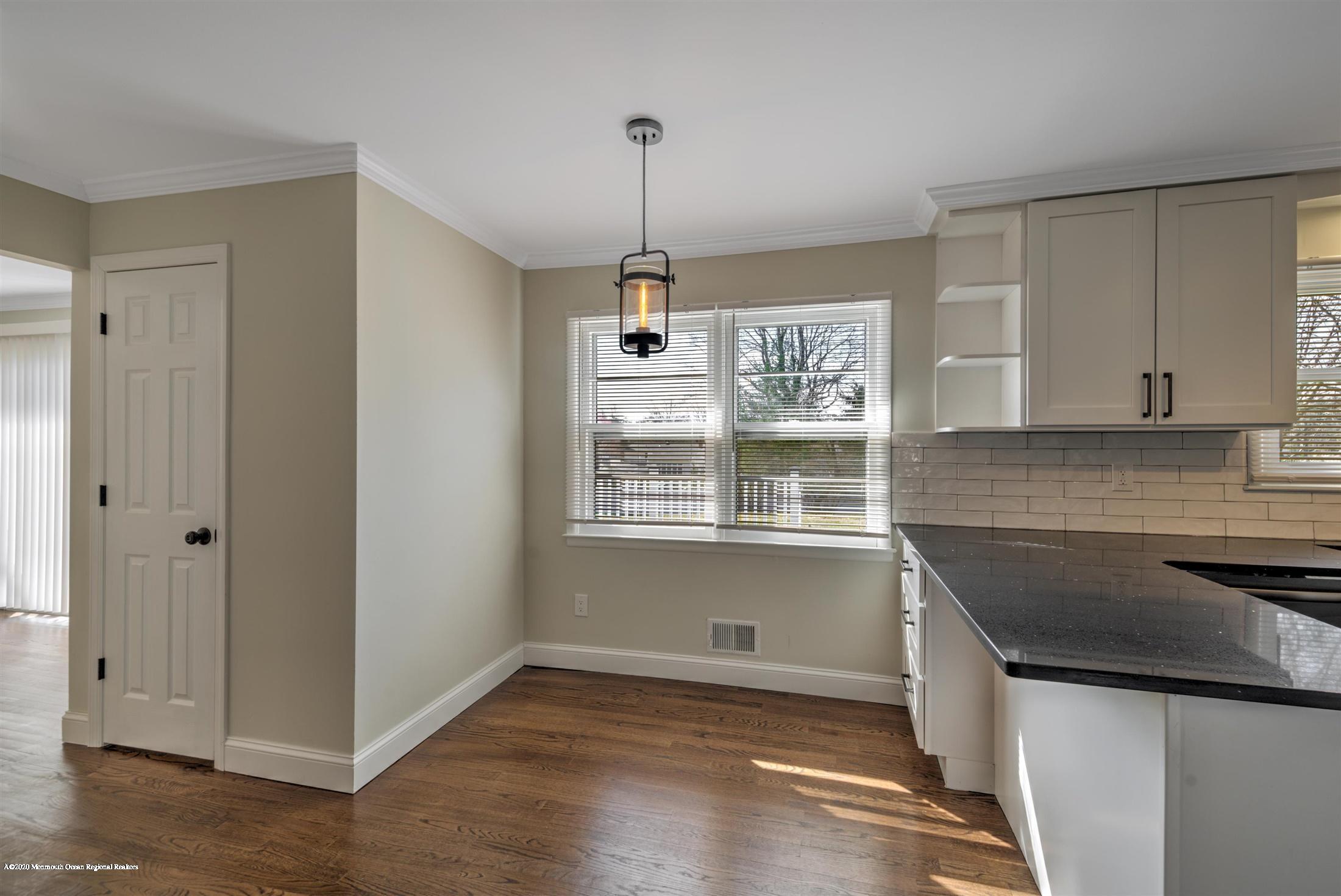 518 East Freehold Road Freehold, NJ 07728 - Photo 5 of 35 a kitchen with kitchen island a counter space a sink and a window