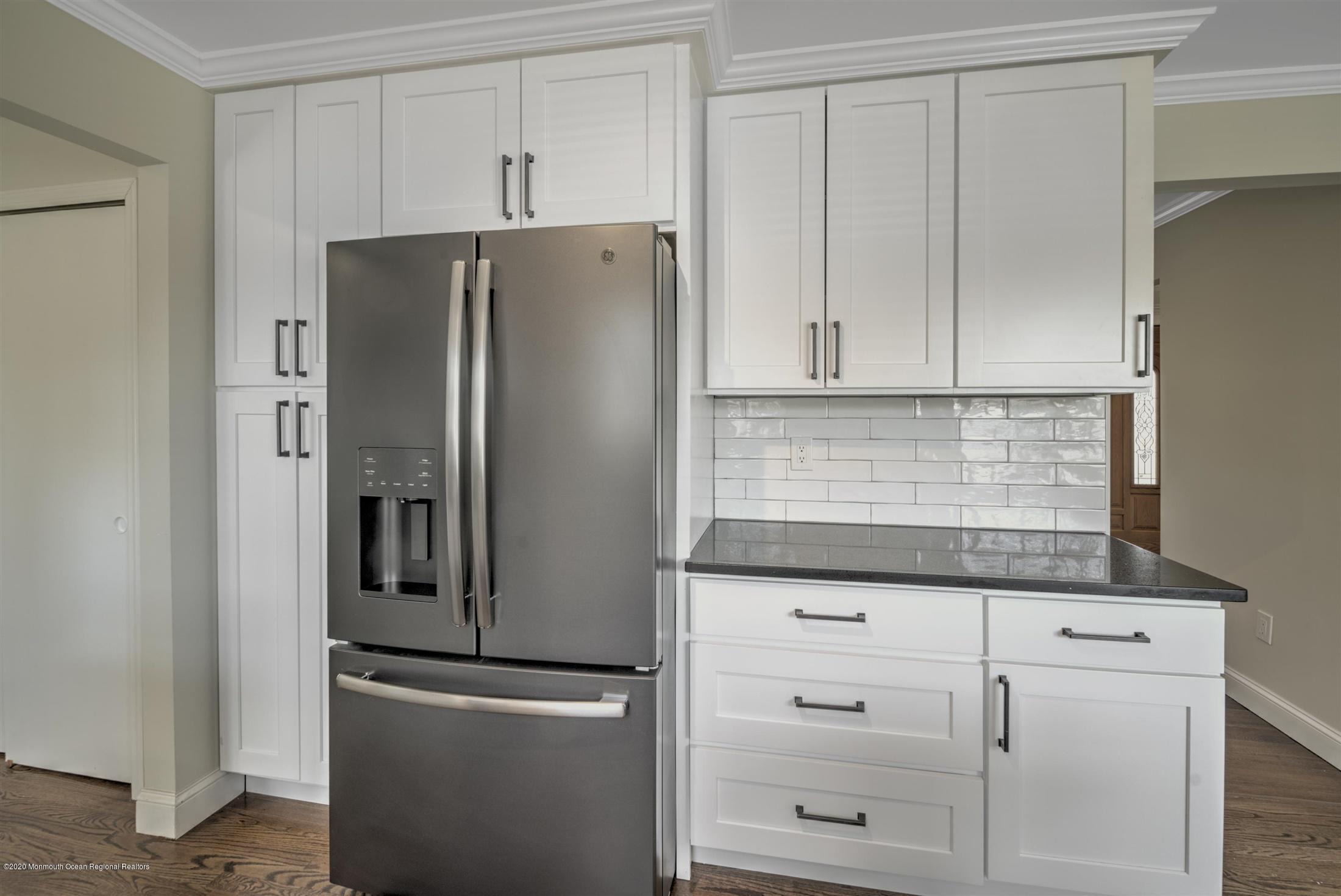 518 East Freehold Road Freehold, NJ 07728 - Photo 8 of 35 a kitchen with white cabinets and stainless steel appliances