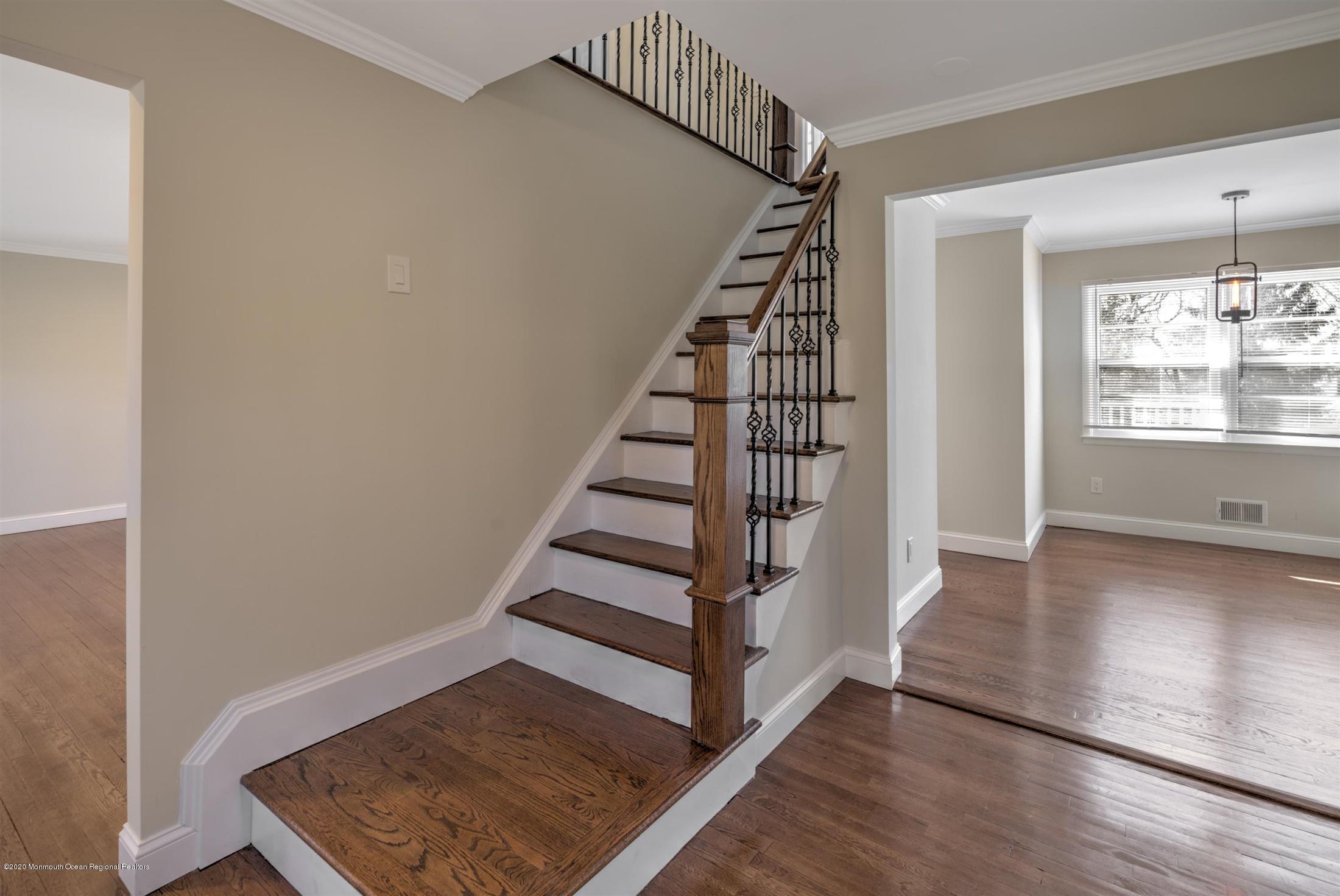 518 East Freehold Road Freehold, NJ 07728 - Photo 10 of 35 a view of entryway with wooden floor and stairs
