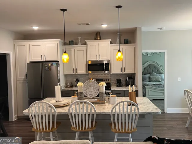 a view of a dining room with furniture wooden floor and chandelier