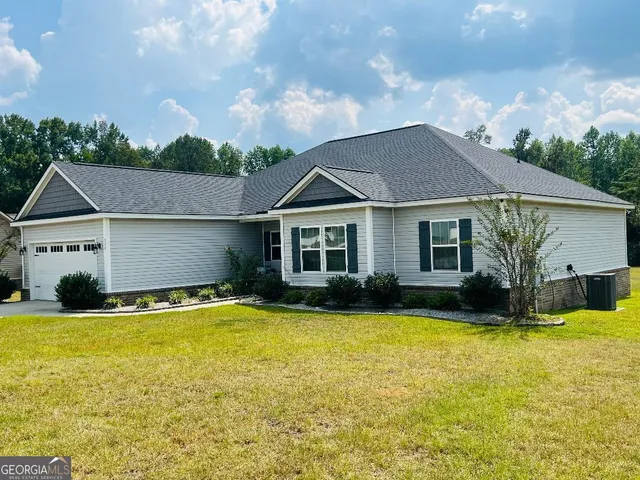 a view of a house with swimming pool and a yard