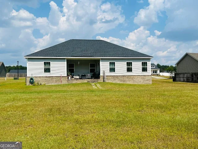 a front view of house with yard and trees