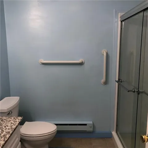 a bathroom with a toilet and a shower