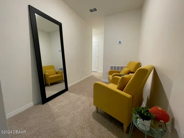 a blue couch sitting in a living room with a rug