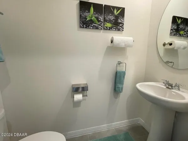 a white toilet sitting next to a bathroom sink and vanity