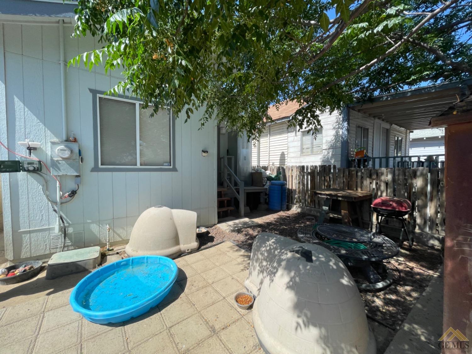 Undisclosed Address Taft, CA 93268 - Photo 13 of 17 a view of a chairs and table in backyard