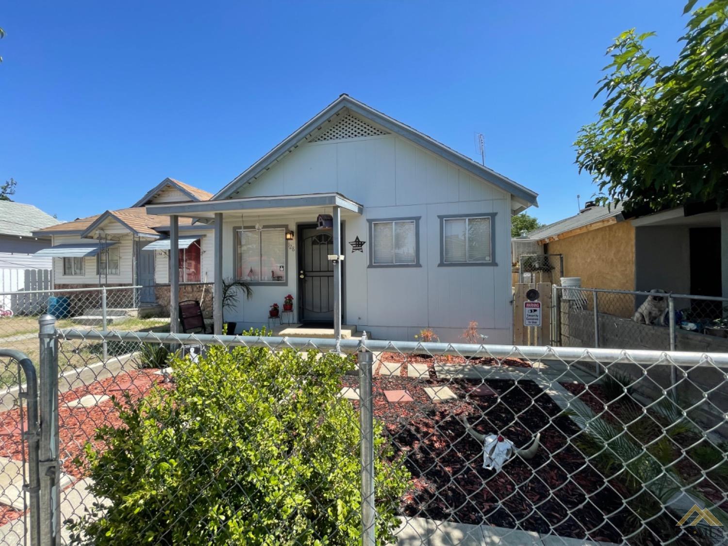 Undisclosed Address Taft, CA 93268 - Photo 3 of 17 a front view of a house with a yard