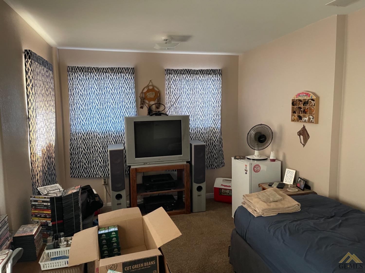 Undisclosed Address Taft, CA 93268 - Photo 7 of 17 a living room with furniture a flat screen tv and a fireplace