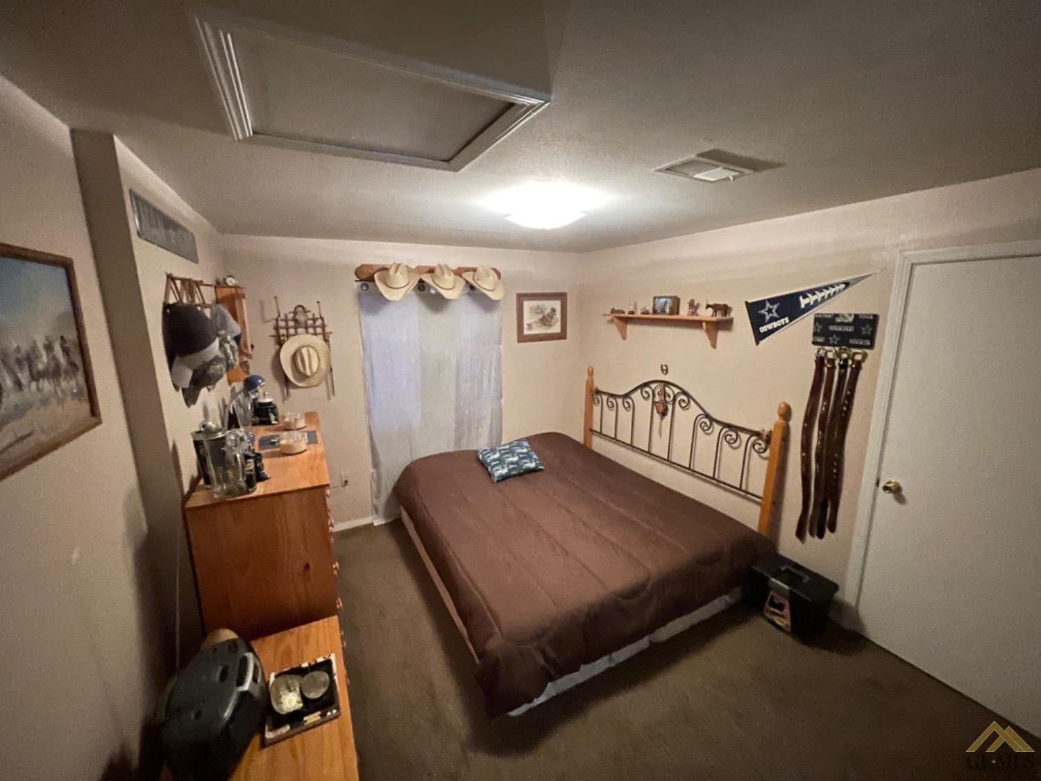 Undisclosed Address Taft, CA 93268 - Photo 10 of 17 a bedroom with a bed and a window