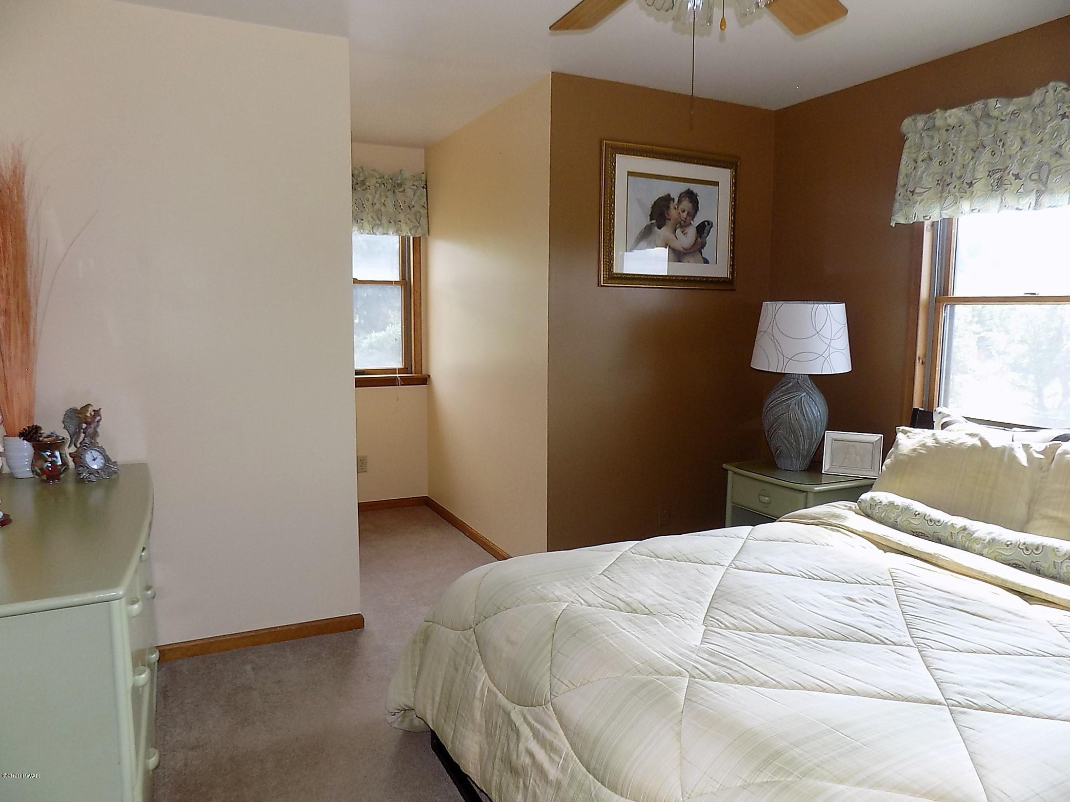 171 Valleyview Road Greentown, PA 18426 - Photo 81 of 111 a bedroom with a bed and a lamp on dresser