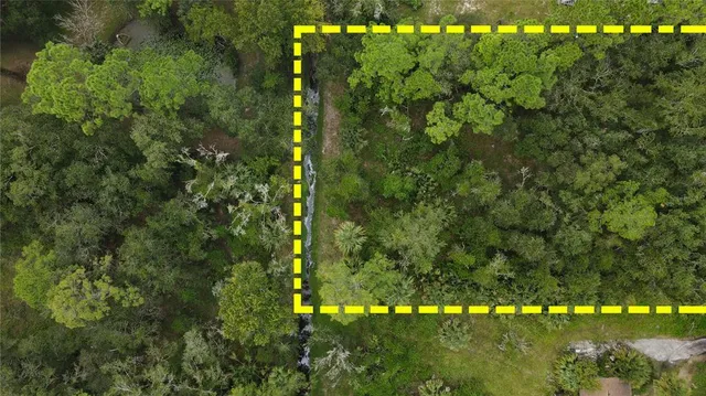 a swimming pool view with a seating space and a garden view