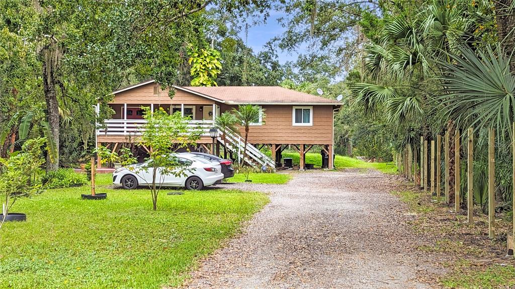 25212 Luke Street Christmas, FL 32709 - Photo 17 of 26 a front view of a house with garden