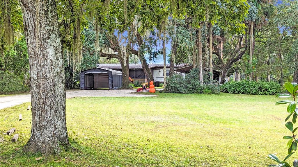 25212 Luke Street Christmas, FL 32709 - Photo 21 of 26 a swimming pool with outdoor seating and yard