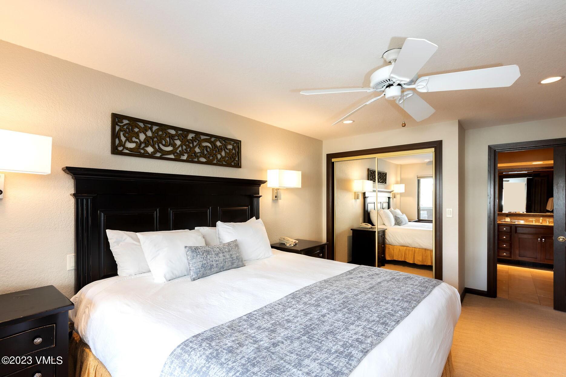 210 Offerson Road, Unit 312 WEEK 48 Beaver Creek, CO 81620 - Photo 13 of 23 a bedroom with a large bed and a chandelier