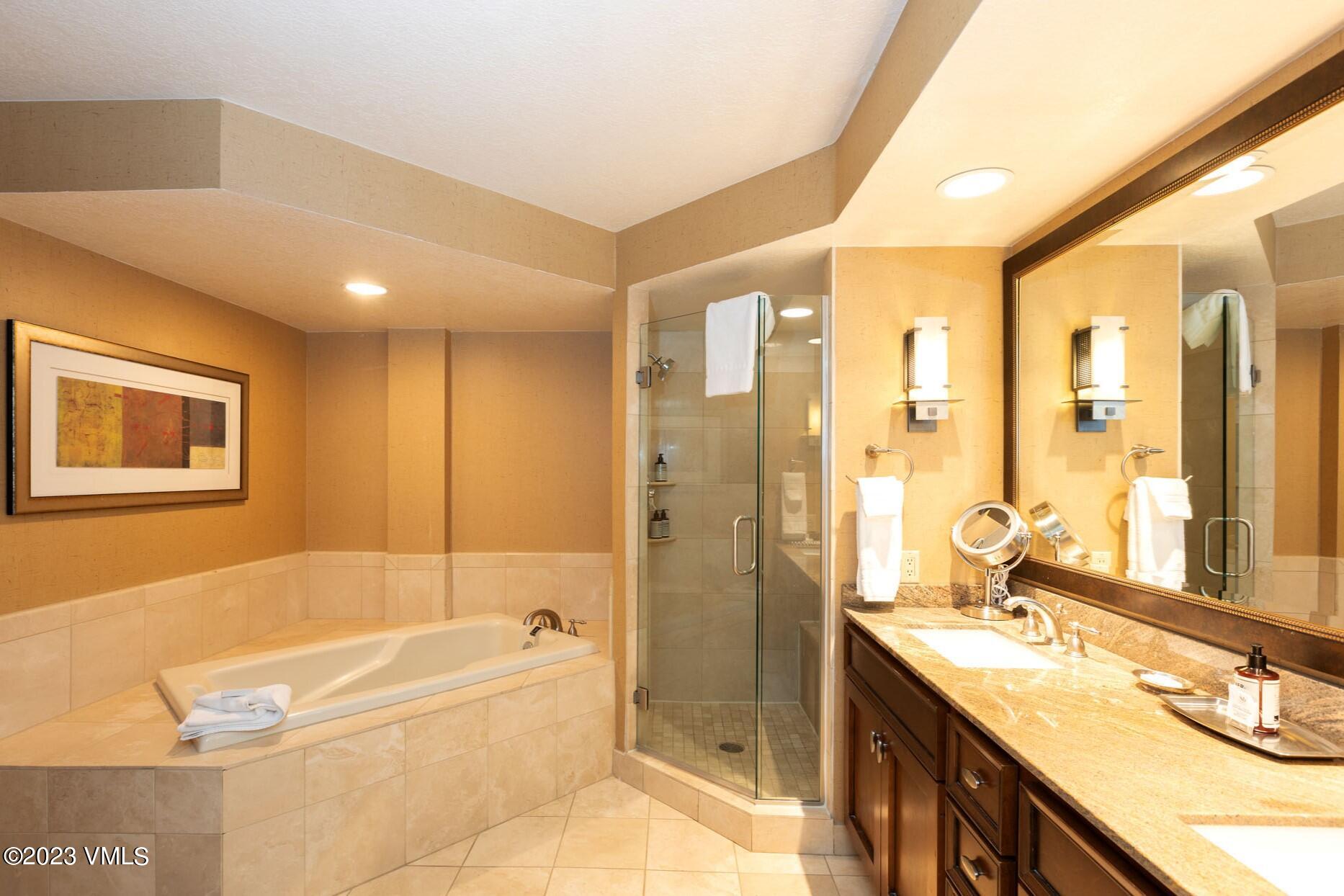 210 Offerson Road, Unit 312 WEEK 48 Beaver Creek, CO 81620 - Photo 15 of 23 a bathroom with a tub sink shower and a mirror