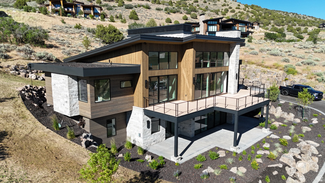 1918 Chimney Rock Road Heber City, UT 84032 - Photo 2 of 74 Contemporary architectural design featuring wood-finish siding, stone accents, and a multi-level deck