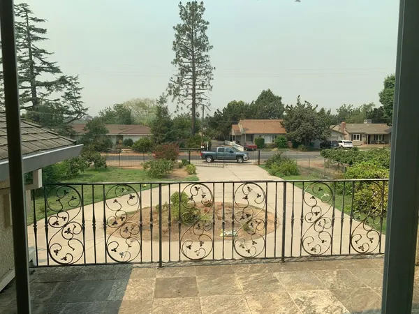 a view of a pathway with a wrought fence