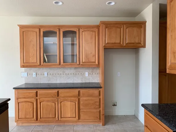 a bathroom with granite countertop a sink and a stove