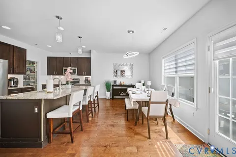 a view of a dining room with furniture window and wooden floor