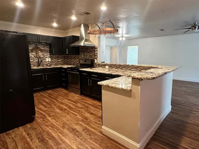 a kitchen with stainless steel appliances granite countertop a stove and a sink