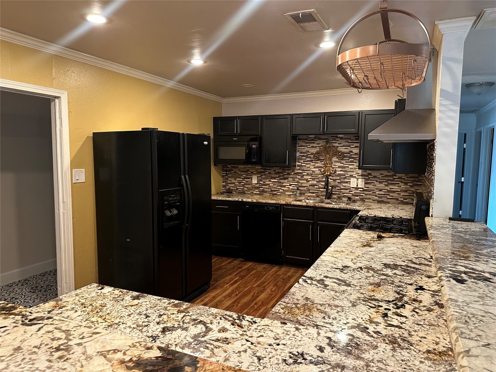 6004 Palm Circle Austin, TX 78741 - Photo 11 of 27 a kitchen with stainless steel appliances kitchen island granite countertop a refrigerator and a sink