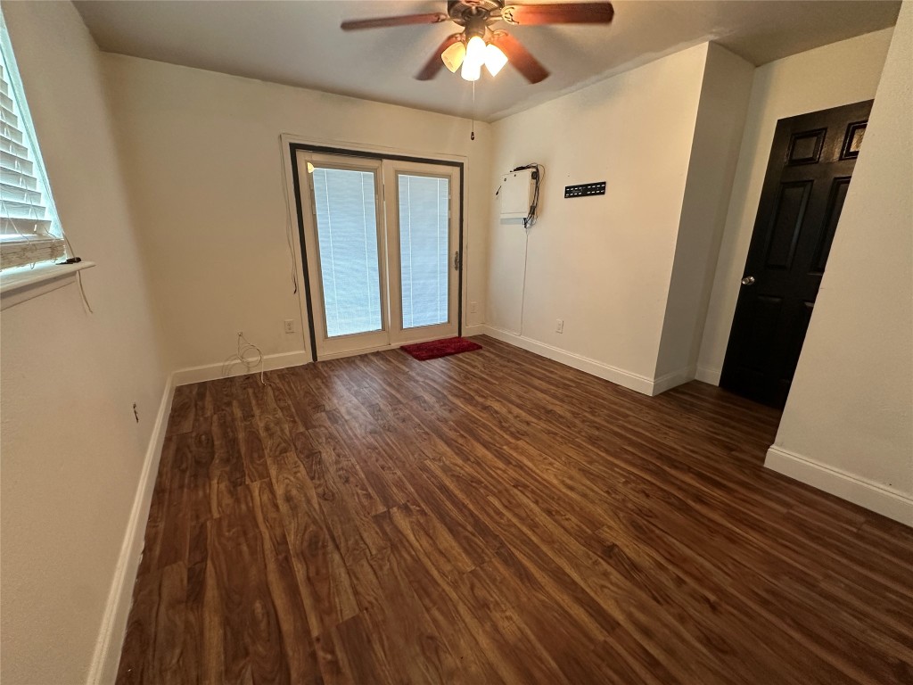 6004 Palm Circle Austin, TX 78741 - Photo 16 of 27 a view of an empty room with wooden floor and a window