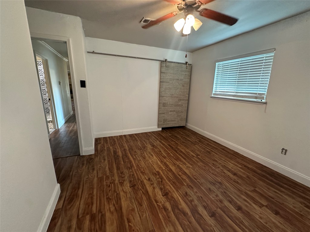 6004 Palm Circle Austin, TX 78741 - Photo 17 of 27 wooden floor in an empty room with a window