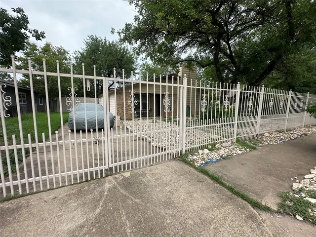 a view of a gate with wooden fence