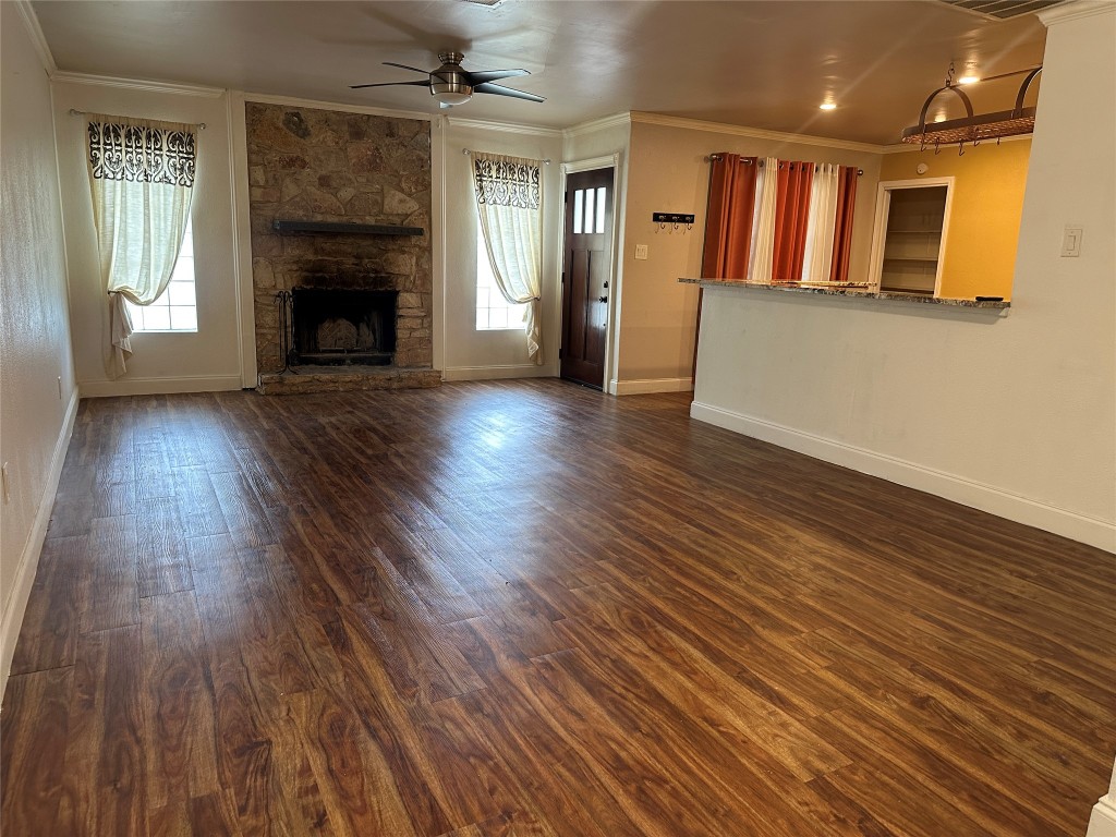 6004 Palm Circle Austin, TX 78741 - Photo 6 of 27 an empty room with wooden floor and a fireplace