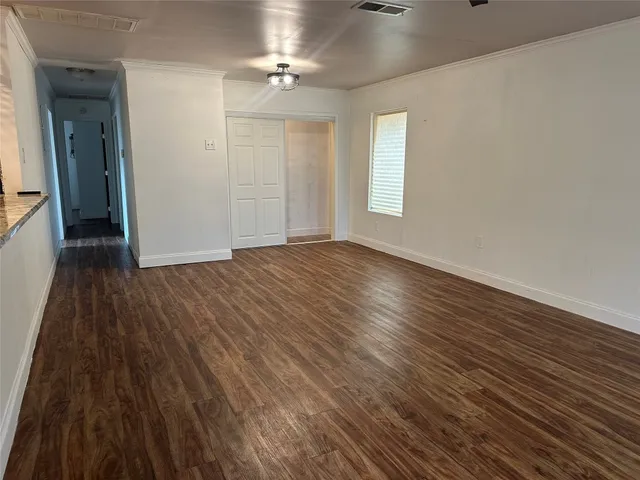 wooden floor in an empty room with a window