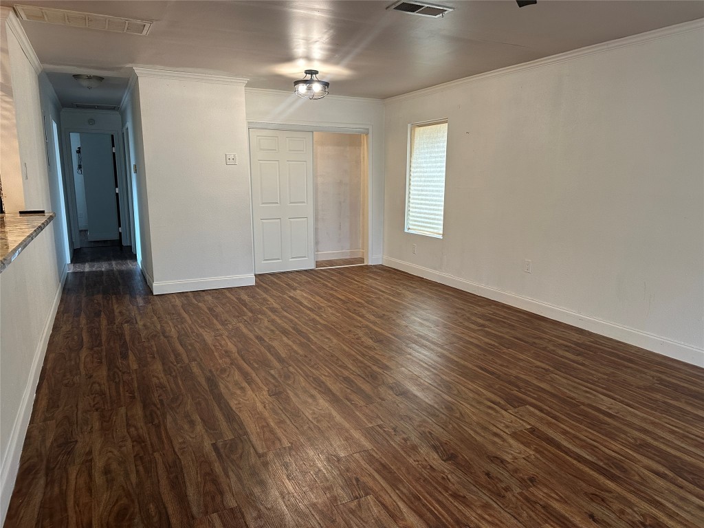 6004 Palm Circle Austin, TX 78741 - Photo 7 of 27 wooden floor in an empty room with a window