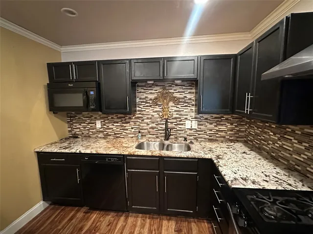 a view of a livingroom with a stove and kitchen floors
