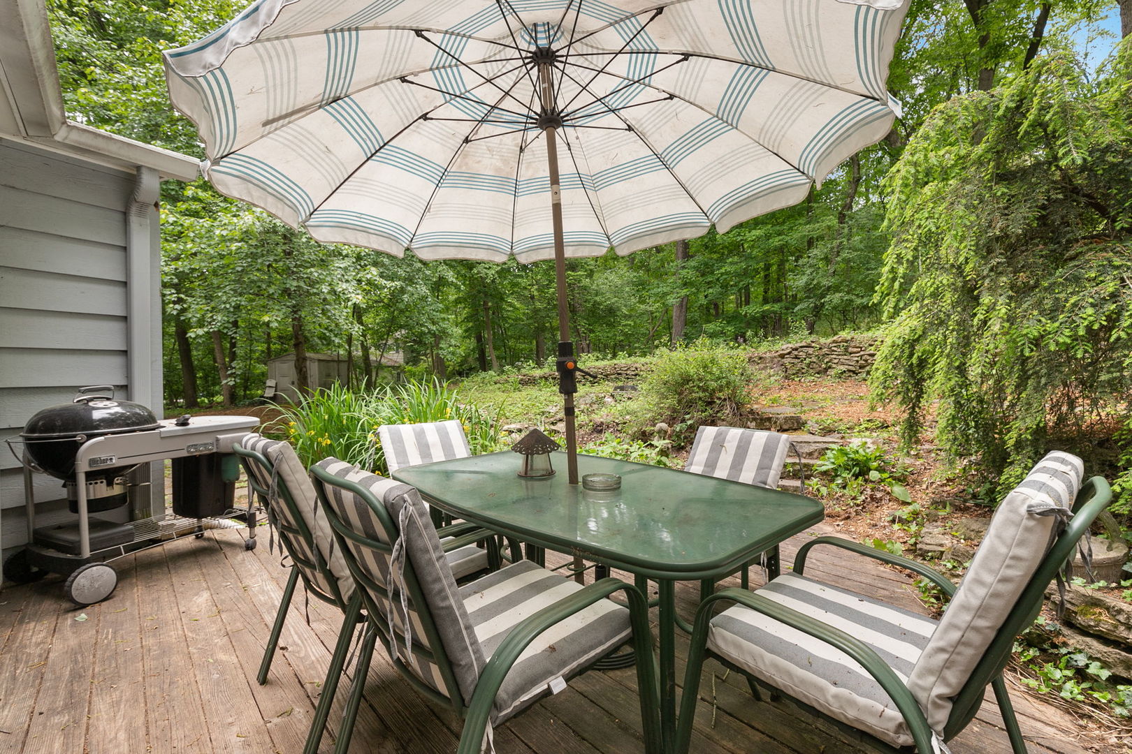 36W525 Wild Rose Road St. Charles, IL 60174 - Photo 28 of 39 a view of a patio with a table and chairs under an umbrella