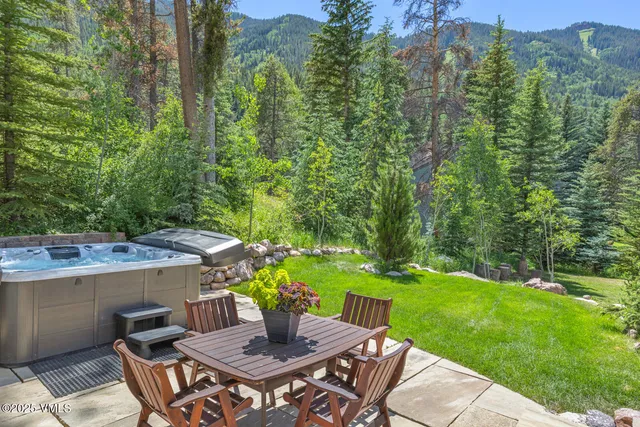 a view of a backyard with table and chairs and potted plants