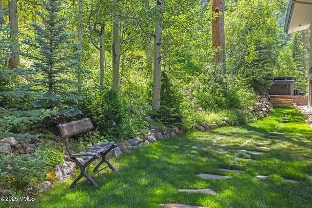 a backyard of a house with table and chairs