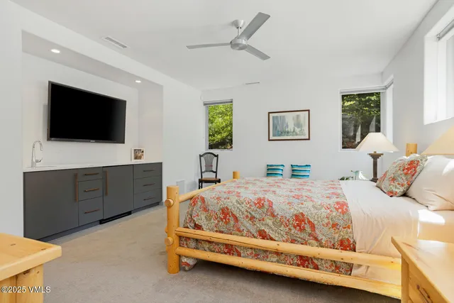 a bedroom with a bed and a flat screen tv