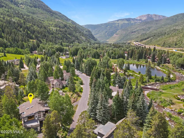 an aerial view of residential house with an outdoor space and mountain view