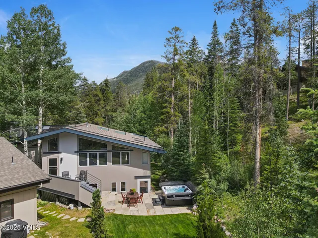 a view of a house with backyard sitting area and garden