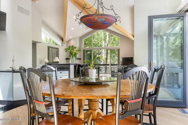 a view of a dining room with furniture wooden floor and chandelier