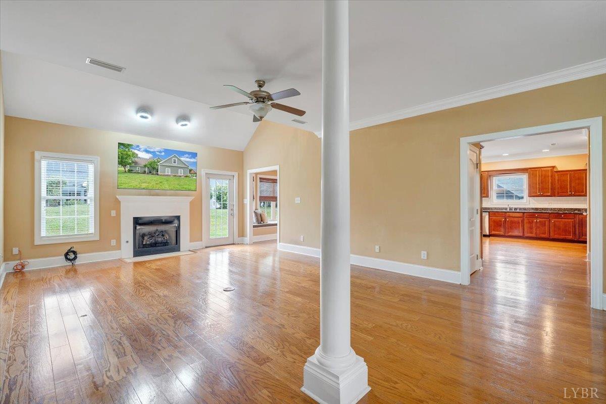 1250 Our Cove Road Huddleston, VA 24104 - Photo 10 of 70 a view of a livingroom with wooden floor a fireplace and window