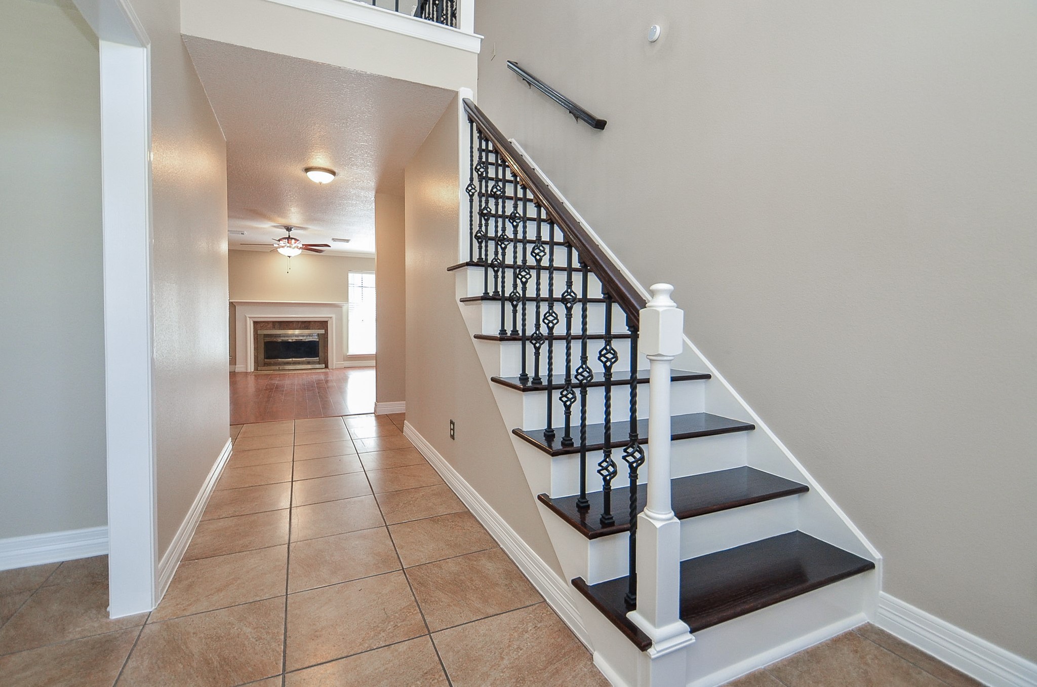 8803 Tweedbrook Drive Spring, TX 77379 - Photo 6 of 36 Notice this breathtaking entryway, with a gorgeous staircase and tile flooring throughout the home.