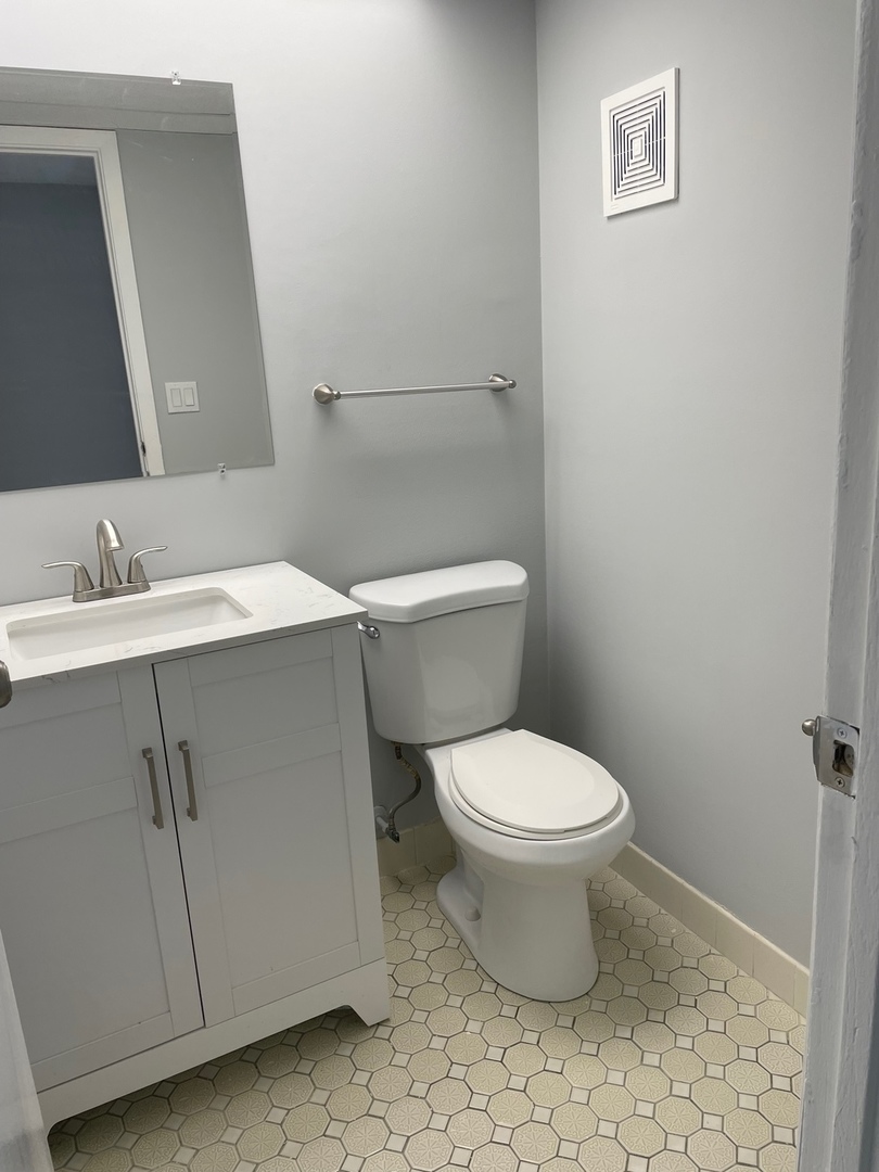 5500 Tinder, Unit 2 Rolling Meadows, IL 60008 - Photo 12 of 14 a white toilet sitting next to a bathroom sink